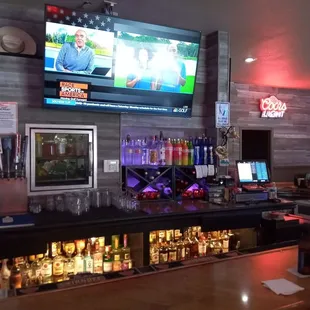 a bar with a television on the wall