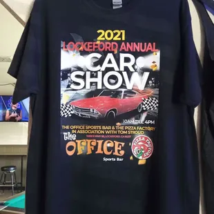 a black t - shirt with a car show advertisement on it