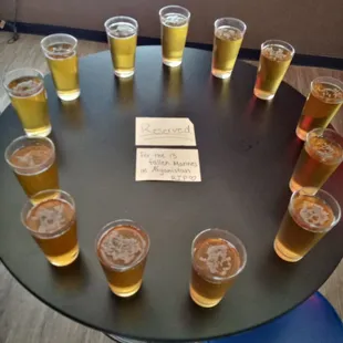 a circle of beer glasses on a table
