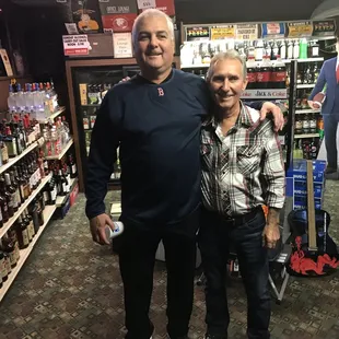 two men standing in a liquor store