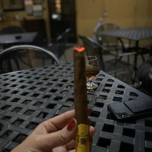 a hand holding a cigar