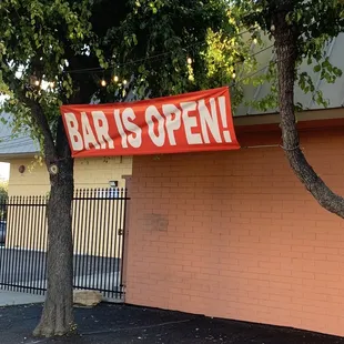 a sign that says bar is open