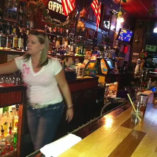 a woman standing at a bar