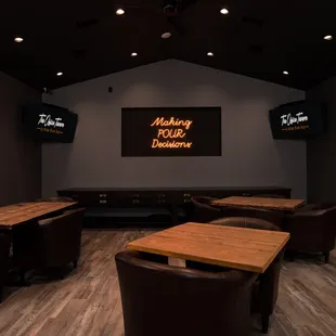 tables and chairs in a dimly lit room