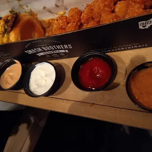Angry smash burger trio with tots from Smash Brothers and sauce flight (classic, garlic mayo, ketchup, and angry sauce)