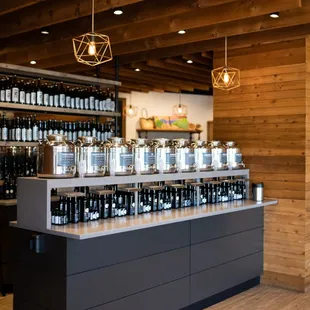 a counter with a variety of bottles of wine