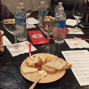 a plate of bread, cheese, and water on a table