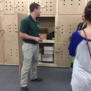 a man in a green shirt and khaki pants