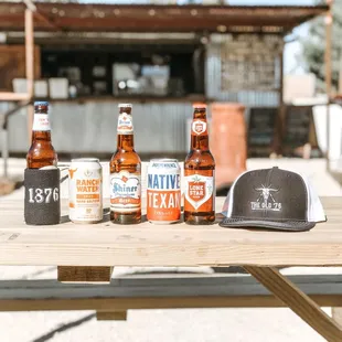  variety of beer bottles on a picnic table