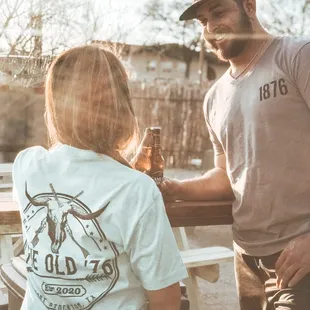  man and a woman sitting at a picnic table
