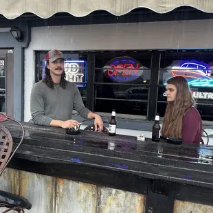 two people sitting at the bar