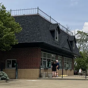 two men standing in front of a building