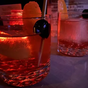 a drink with a garnish garnish