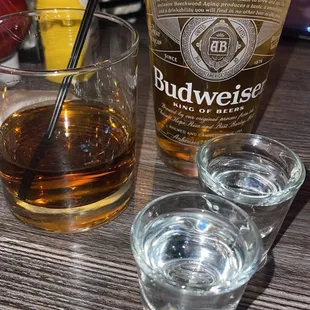 a shot of a drink and two glasses