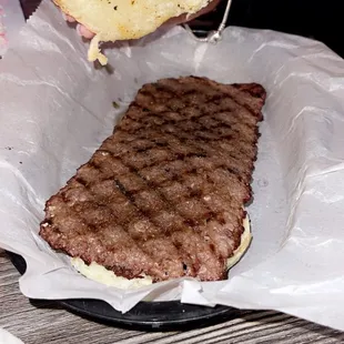 a hamburger being held by a person