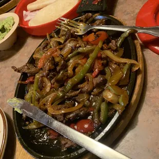 Steak fajitas that I had already started eating. There was so much meat; very generous serving and the price is $14