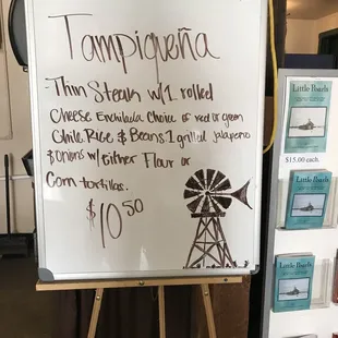 a white board with a price list on it