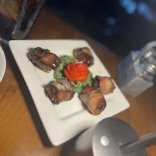 Dates stuff with sausage and wrapped in bacon