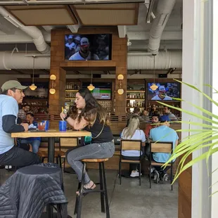 people sitting at tables in a restaurant