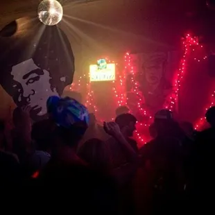 a disco party with a disco ball in the background