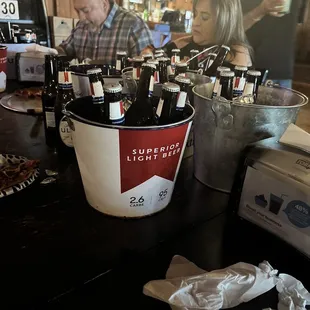 a bucket full of beer bottles