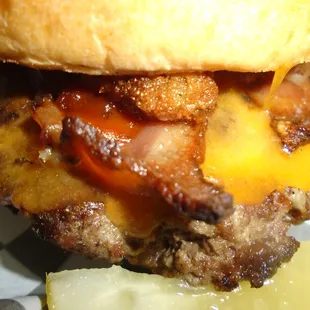 Heine&apos;s Tavern Burger on a Pretzel Bun, close-up.