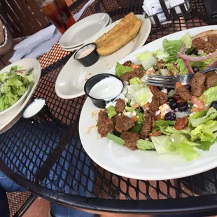 Sinful chicken with greens and black and blue salad.