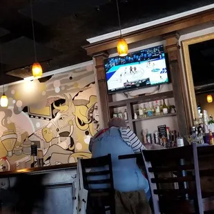 two people sitting at a bar