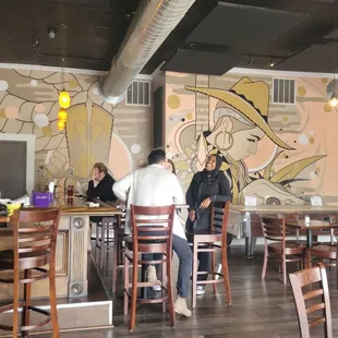 people sitting at tables in a restaurant