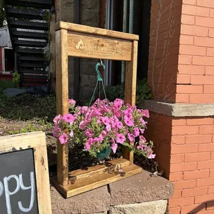 a wooden frame with flowers in it