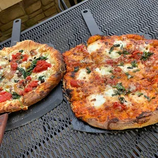 two pizzas on a table
