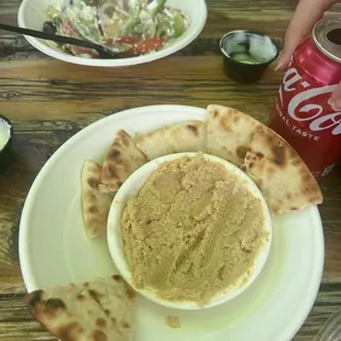 Hummus and Greek salad half eaten.