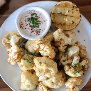 Crispy cauliflower served with tahini dipping sauce.