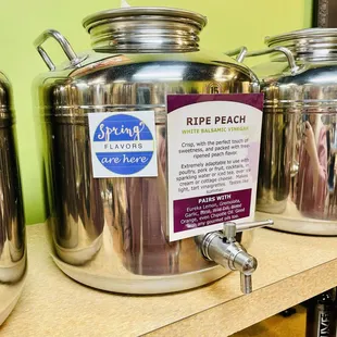 a row of stainless steel containers with labels on them