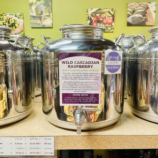 a row of stainless steel containers with labels on them