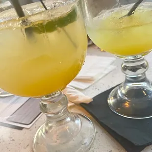 two glasses of lemonade on a table