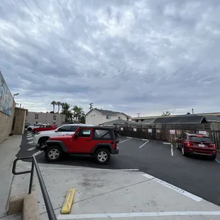 a red jeep parked in a parking lot