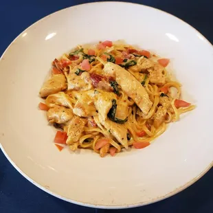 a plate of pasta with chicken