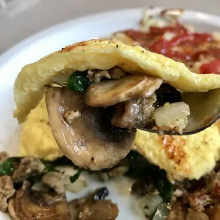 an omelet with mushrooms and spinach