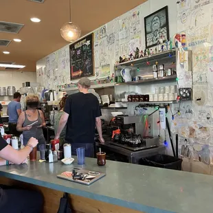 a group of people sitting at a bar