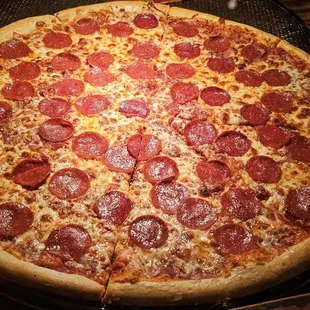 a pepperoni pizza on a pan