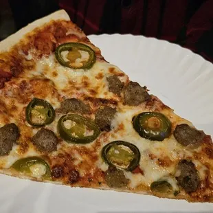 a slice of pizza on a paper plate