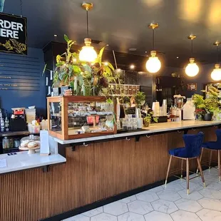 a coffee shop with a counter and chairs