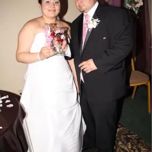 Cutting the cake next to the sweetheart table
