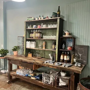 a wooden table with a shelf of jars and jars on it