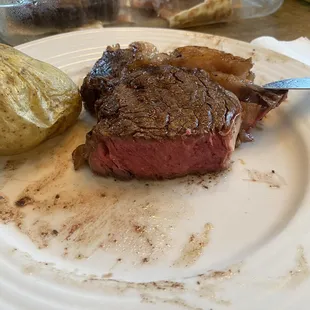 a plate of steak and potatoes