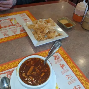 Hot and sour soup and complimentary wonton strips w hot mustard and duck sauce for dipping