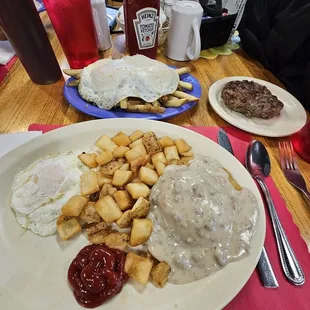 1/2 order of sausage gravy and biscuits front), 1/2 order of Cheesy Greek fries added  eggs (back), side of their homemade sausage patty.