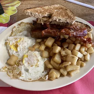 The East Side, over well eggs, home fries, bacon and sausage, wheat toast