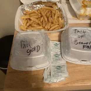 a tray of french fries and a tray of french fries